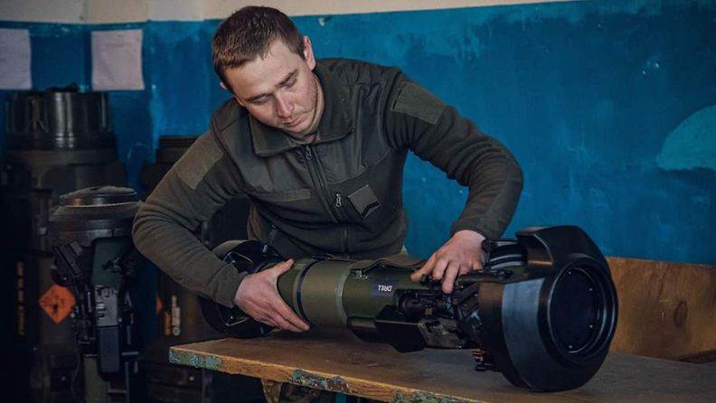 Ukrainalainen sotilas esittelee ruotsalais-brittiläisen NLAW-panssarintorjunta-aseen toimintaa.