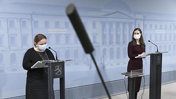 Perhe- ja peruspalveluministeri Krista Kiuru (vas.) ja pääministeri Sanna Marin, kummatkin SDP:stä, tiedotustilaisuudessa tammikuussa 2021.