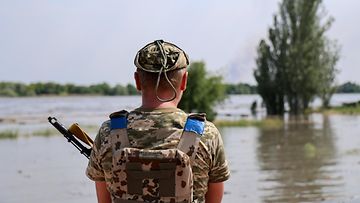 Ukrainalaissotilas tulvivassa Hersonissa 6. kesäkuuta.