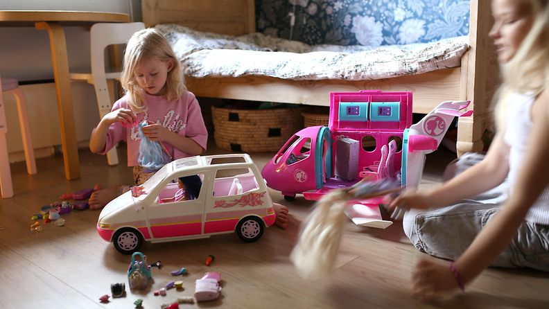 Timon tyttäret leikkivät Timon suunnittelemilla leluilla: käytössä Barbie Mini van car Picnic Camping vuodelta 1995 sekä Barbien lentokone, Barbie Dream Plane.