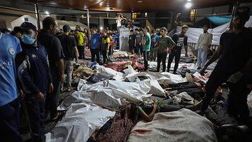 LK 17.10.2023 Ihmiset kerääntyvät Gazassa sijaitsevaan Ahli Arab -sairaalassa Israelin iskuissa surmansa saaneiden palestiinalaisten ruumiiden ympärille sen jälkeen, kun heidät oli kuljetettu Al-Shifa-sairaalaan 17. lokakuuta 2023.