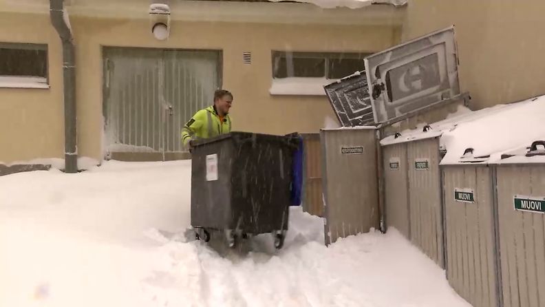 MTV HSY:n jätteenkuljetusauton kuljtettaja työssään lumisena talvipäivänä 18.1.2024.