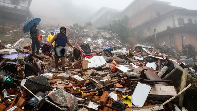 People search for victims or belongings in the debris caused by a landslide in Petropolis, Rio de Janiero state, Brazil, 23 March 2024.