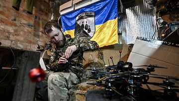 Ukrainan sotilas säätää FPV-dronea.